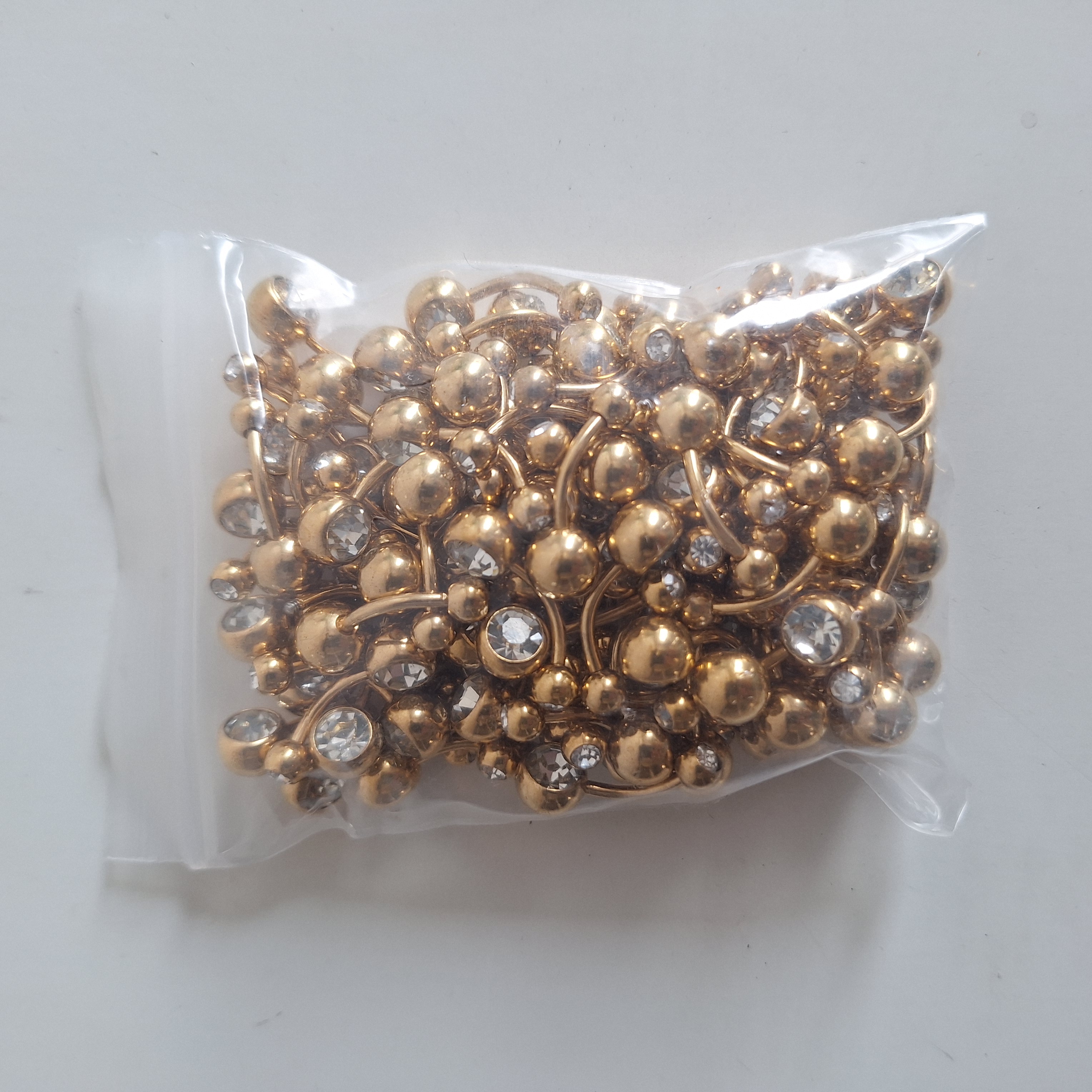 Piercing Ombligo Dorado, con doble piedra 